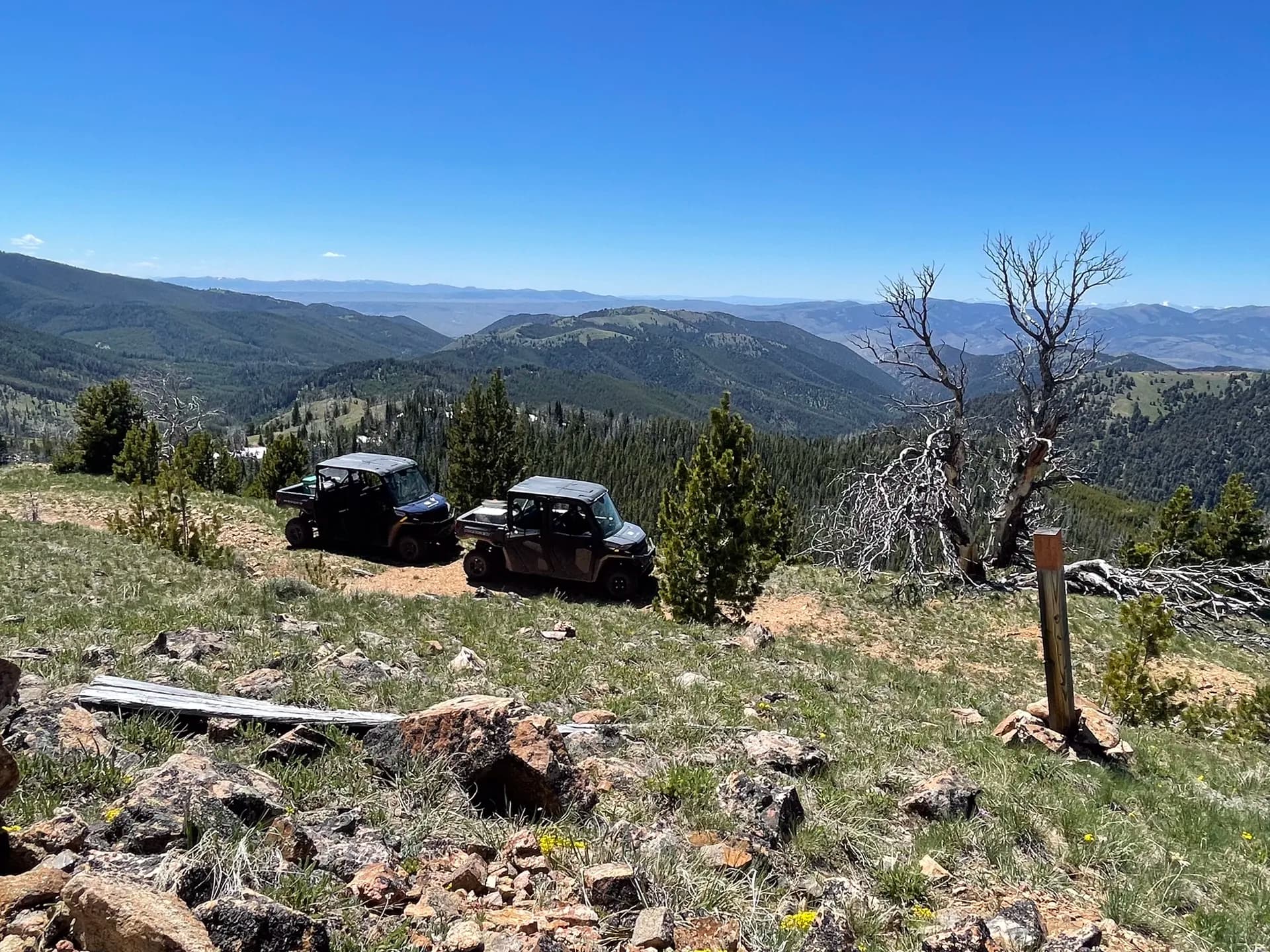 Polaris vehicles at a mountain overlook above the valley